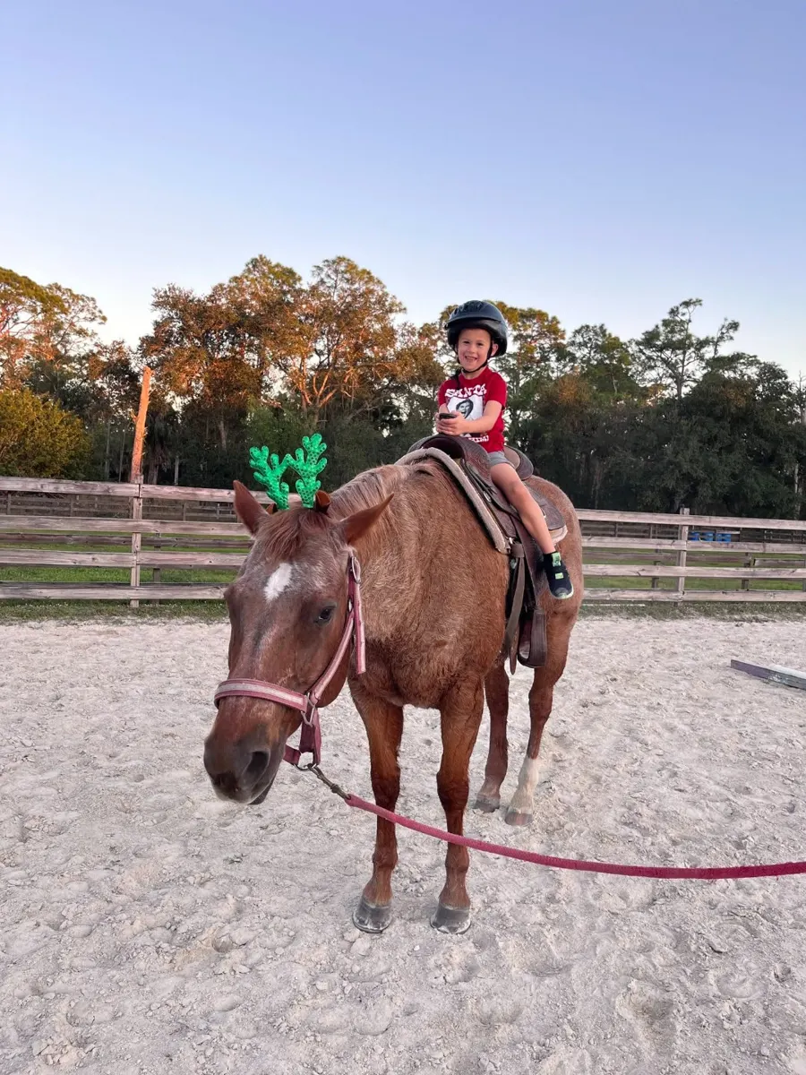 A boy riding a horse