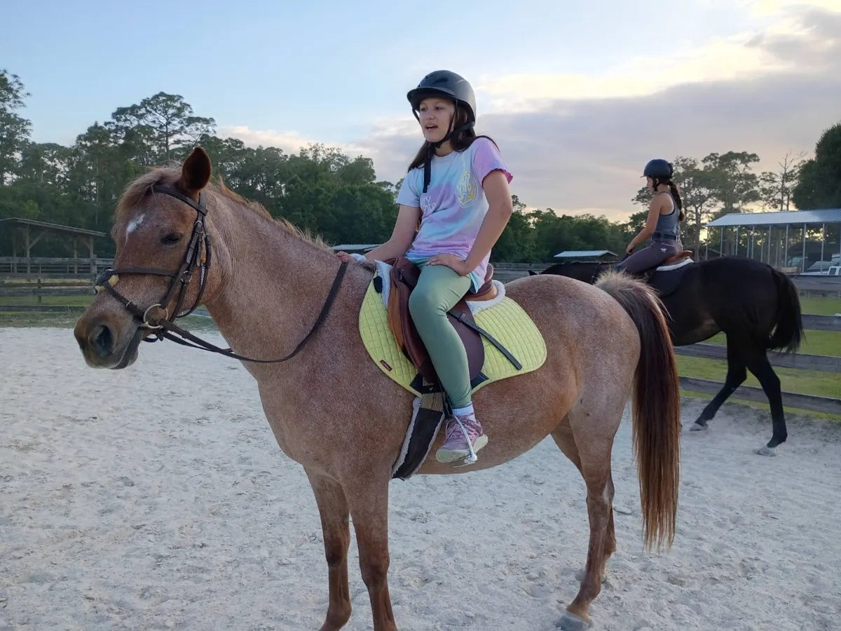 A camper riding in the arena